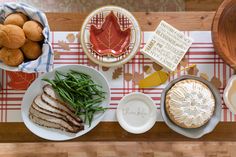 a table topped with plates and bowls filled with food