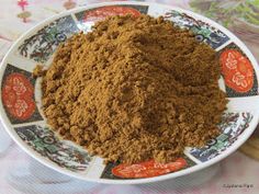 a bowl filled with brown powder on top of a table