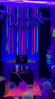 a party with neon lights, balloons and streamers