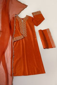 A beautiful festive look in the captivating shade of burnt orange, crafted on pure raw silk in a long kameez silhouette, heavily embellished with gold zardozi craftsmanship, each stitch is a testament to generations of artistry. Completing this masterpiece of a design is a fully embellished soft pure organza dupatta, a Long Kameez, Punjabi Suits Party Wear, Festive Look, Organza Dupatta, Punjabi Suits, Party Wear Dresses, Bridal Designs, Formal Wedding, Pakistani Fashion