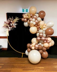 the balloon arch is made up of many different types of balloons, including white and gold