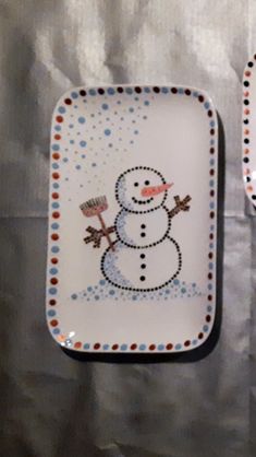 two plates with snowmen painted on them