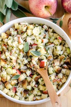 a white bowl filled with apples and stuffing