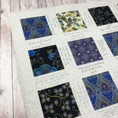 a quilted table topper with nine different designs on it, all in blue and green