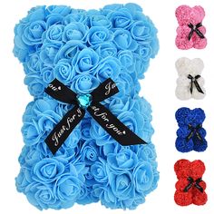 a teddy bear made out of blue roses with black ribbon and name on the front