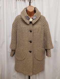 Vintage 1960's Oversized Brown Black & Cream Plaid Tweed Cotton Wool Blend Jacket Coat w Thick Lining, Cape Sleeves, Gold Compass Closure.  The coat is in Excellent condition...see pics! Measurements when buttoned closed: shoulder to shoulder 18 in, chest 46 in, sleeves shoulder to cuff 20 1/2, sleeves pit to cuff 14, back of neck to bottom length 32 1/2 inches. Vintage Tweed Long Sleeve Jacket, Vintage Wool Coat For Workwear In Fall, Vintage Wool Coat For Work, Vintage Oversized Single Breasted Outerwear, Vintage Oversized Single-breasted Outerwear, Vintage Plaid Tweed Jacket, Vintage Black Long Sleeve Tweed Jacket, Vintage Houndstooth Outerwear For Winter, Vintage Black Tweed Workwear Jacket