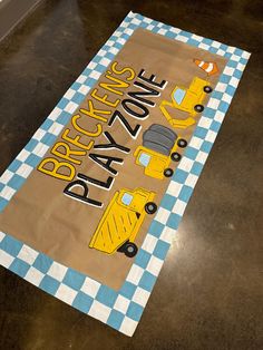 a play mat with construction vehicles and checkered tablecloth on it that says practice zone