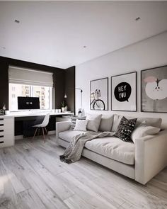 a living room filled with white furniture and pictures on the wall next to a computer desk