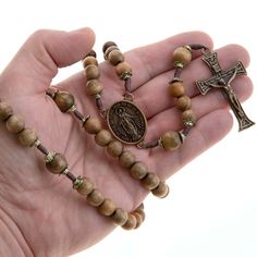 "Introducing our exquisite Large Five Decade Catholic Rosary Beads, a sacred tool designed to deepen your devotion and prayer life. Crafted with utmost reverence, this rosary embodies the timeless traditions of our Catholic faith. The beads of solid Brazilian walnut wood, are a testament to the natural beauty of God's creation. Smooth and perfectly round, they invite your fingers to glide gently over their surface, fostering a tactile connection as you recite your prayers. With ample spacing bet Adjustable Spiritual Rosary With Miraculous Medal, Spiritual Rosary With 8mm Beads For Blessing, Spiritual Rosary With Round Beads For Meditation, Spiritual Rosary For Meditation With Round Beads, Spiritual Beaded Rosary For Blessing, Spiritual Necklace With Miraculous Medal And Round Beads, Crucifix Rosary With 8mm Beads For Meditation, 8mm Bead Crucifix Rosary For Meditation, Spiritual Rosary With 108 Beads And Crucifix