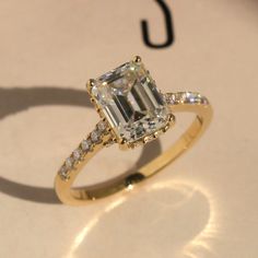 a fancy ring with an emerald cut diamond