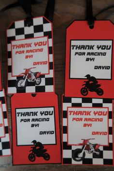 four red and black tags with motorcycles on them that say, thank you for racing