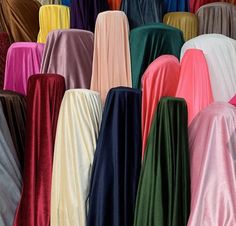 many different colored dresses are lined up together