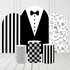 black and white wallpaper with two coffee mugs in front of it, one wearing a tuxedo