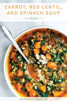 a white bowl filled with carrots and spinach soup on top of a table