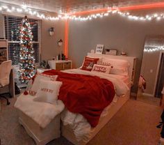 a bed room with a neatly made bed and a christmas tree