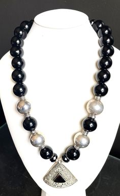 "Big, bold, elegant, dramatic statement necklace Gorgeous rich black onyx beads Afghan Kuchi nomadic medallion pendant of silver and onyx (2.25\"x2.25\") Silver round and filigree beads Silver spacers and toggle clasp Length: 26\" #359 - \"Black Mamba\"" Black Jewelry With Large Beads, Formal Black Jewelry With Large Beads, Black Round Jewelry With Large Beads, Modern Black Round Beads Necklace, Modern Black Necklace With Round Beads, Black Medallion With Large Pendant, Black Onyx Jewelry With Silver Beads, Silver Onyx Necklace With Black Beads, Luxury Black Necklace With 8mm Beads