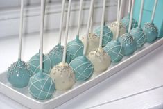 there are many blue and white candies on the tray with toothpicks in them