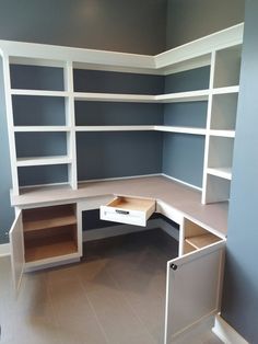 an empty room with shelves and drawers in it