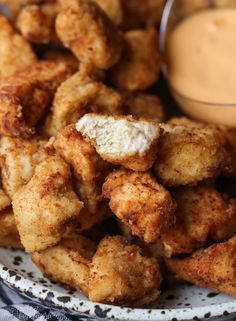 fried food on a plate with dipping sauce