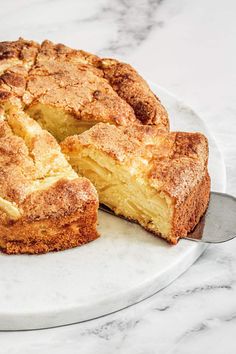 a close up of a cake on a plate with a slice missing from the pie