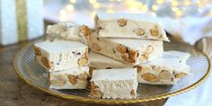 several pieces of cake sitting on top of a glass plate next to a christmas tree