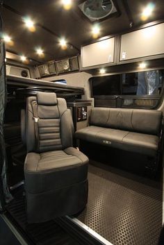 the inside of a vehicle with leather seats and lights on it's ceiling beams