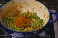 a blue pot filled with food on top of a stove