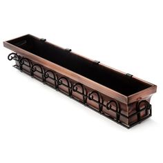 a wooden planter with wrought iron designs