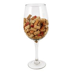 a glass filled with lots of wine corks