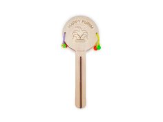 a wooden spoon with the words happy purim on it