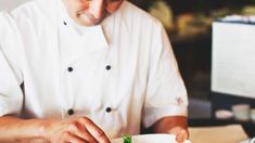 a chef is preparing food on a plate