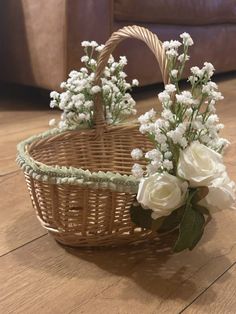 a basket with flowers in it sitting on the floor