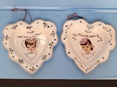 two heart shaped plates with pictures on them