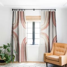 a living room with a chair, rug and window