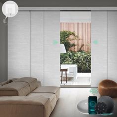 a living room filled with furniture and a sliding glass door