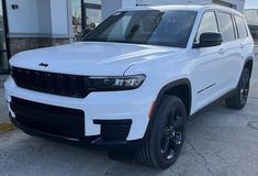 a white jeep parked in front of a building