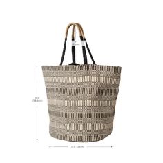 Are you looking for a stylish, eco-friendly bag that’s perfect for the beach or any weekend trip? Look no further than the Dobi Shoulder Tote – Black. This spacious, roomy tote, made of handwoven Jute-Cotton fabric, is stylish and durable enough to withstand however much you choose to carry. Featuring a unique round bottom shape and color accent on the handle, this bag transitions easily into any season. Plus, each product is sustainably handmade by Fair Trade artisans in Bangladesh.The Dobi Sho Casual Straw Beach Bag, Eco-friendly Black Beach Bag, Black Basket Beach Bag For Daily Use, Modern Handwoven Bags For Vacation, Eco-friendly Black Bucket Bag For Travel, Modern Bucket Bag With Braided Handles For Beach, Modern Beach Bucket Bag, Black Woven Basket Bucket Bag, Modern Handwoven Straw Bag For Everyday Use