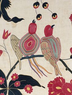 two birds sitting on top of a tree branch with flowers and leaves painted on it