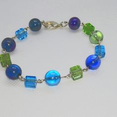 Multicolor Beaded Silver Adjustable Blue-green Beaded Jewelry, Multicolor Czech Glass Beaded Chain Bracelets, Iridescent Beaded Bracelets For Jewelry Making, Multicolor Czech Glass Bracelet With Spacer Beads, Multicolor Czech Glass Crystal Bracelet With Spacer Beads, Multicolor Beaded Glass Crystal Bracelet, Iridescent Beaded Bracelets With Colorful Beads, Colorful Czech Glass Beaded Bracelets For Parties, Party Bracelets With Colorful Czech Glass Beads