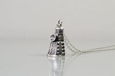 Dr Who Necklace 925 Silver Dalek Jewelry Doctor Who Geek Nerd Jewelry Gift Handcrafted Dalek necklace made from .925 sterling silver. Unisex statement necklace. All my jewelry are custom made so please allow 4-6 business days before shipment. Material .925 sterling silver Pendant size: 1.3cm x 2.5cm The item is nicely packaged and ready to gift in an nice eco-friendly jewelry box, secured to arrive safely at your door. Nerd Jewelry, Geek Jewelry, Eco Friendly Jewelry, Dr Who, Diy Earrings, Doctor Who, Sterling Silver Pendants, Jewelry Gift, Silver Pendant