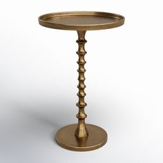 a golden metal table with a circular base