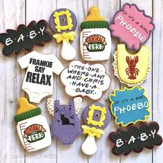 decorated cookies are arranged in the shape of baby's names and other things to eat