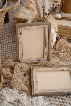 an old photo frame sitting on top of a table next to two vases filled with flowers