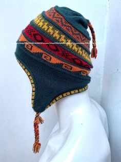 "Unisex Peruvian Alpaca Hat chullo with Earflaps 100% Lining, Soft Fleece Lining Beanie hat, alpaca chullo peruvian hat, peru hat, alpaca hat 100 % Alpaca - High Quality - 100% Lining This is a brand new one of a kind chullo hat made of alpaca, one of the finest yarns in the world. It is soft and warm and features an exquisite intarsia design in a gorgeous color combination. Color combinations are unique due to the handcrafted nature of the product. Order is by main color. Alpaca is considered o Bohemian Adjustable Bonnet For Winter, Artisan Adjustable Winter Hats, Bohemian Brimmed Winter Bonnet, Adjustable Alpaca Hat For Outdoor, Adjustable Alpaca Winter Hat, Bohemian Winter Hats With Ear Flaps, Bohemian Hats For Cold Weather, Bohemian Brimmed Beanie For Winter, Traditional Beanie Hats For Winter