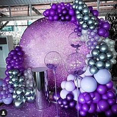 purple and silver balloons are on display at an event