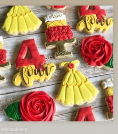 decorated cookies are arranged on top of a wooden table with the words princess spelled out