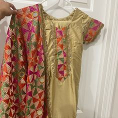 Gold Phulkari Salwar Suit. Dupatta And Embroidered Salwar Included. Brand New, Never Worn. Length 35" Chest 16" Waist 14" Hips 18" Salwar Length 38" Salwar Ankle 7" Bollywood Style Churidar For Traditional Ceremonies, Fitted Multicolor Embroidered Chanderi Salwar Kameez, Fitted Churidar With Multicolor Embroidery For Navratri, Bollywood Style Fitted Salwar Kameez With Multicolor Embroidery, Festive Fitted Salwar Kameez With Multicolor Embroidery, Fitted Multicolor Embroidered Salwar Kameez For Diwali, Festive Salwar Kameez With Multicolor Embroidery And Traditional Drape, Festive Multicolor Raw Silk Salwar Kameez, Traditional Multicolor Churidar For Transitional Season