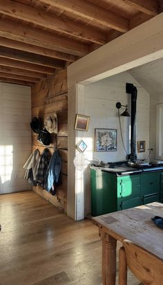 a kitchen with an oven, stove and table in it