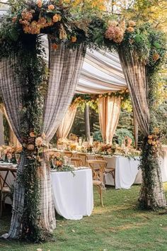 An elegant fall wedding garden setup with floral-adorned draped curtains and rustic greenery, creating a romantic outdoor atmosphere perfect for an October wedding ceremony. Elegant Fall Wedding, Wedding Garden, Elegant Fall