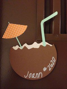 a brown door with a sign that says jaan and an umbrella